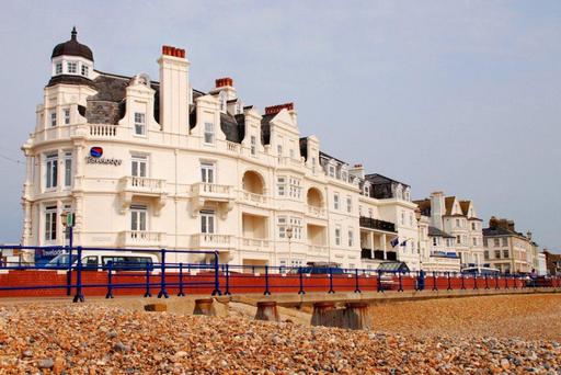 Travelodge, Marine Parade, Eastbourne with a pebble beach in the foreground
