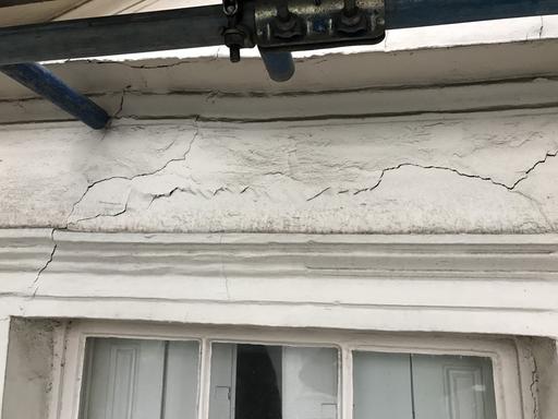 Lateral crack in the wall above a window showing sings of lintel failure